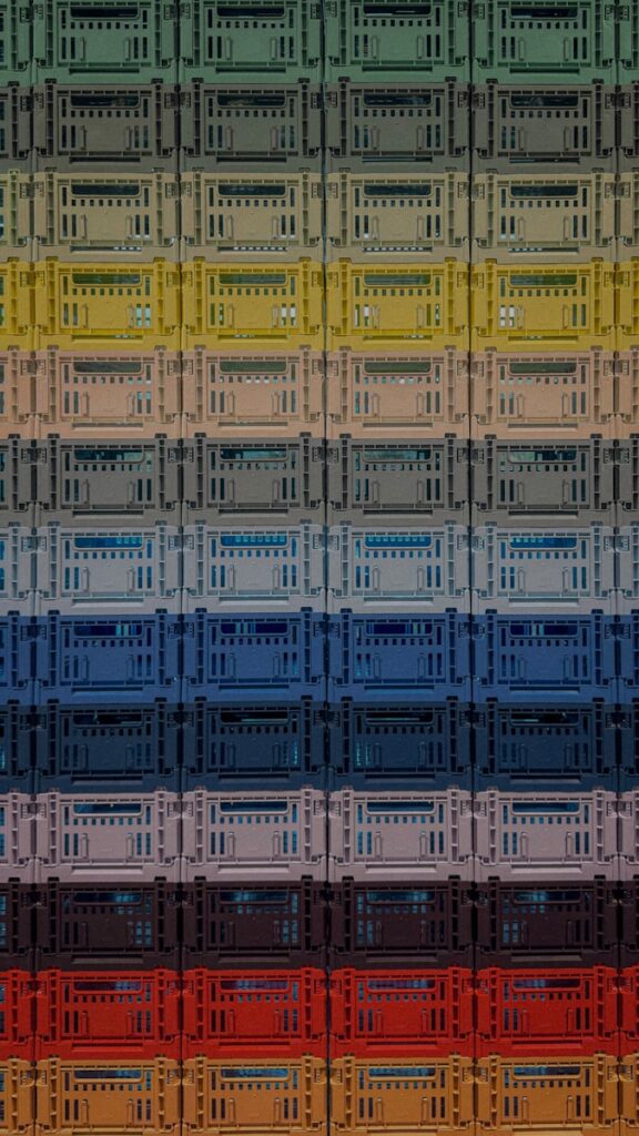 Stack of colorful plastic crates in a gradient.